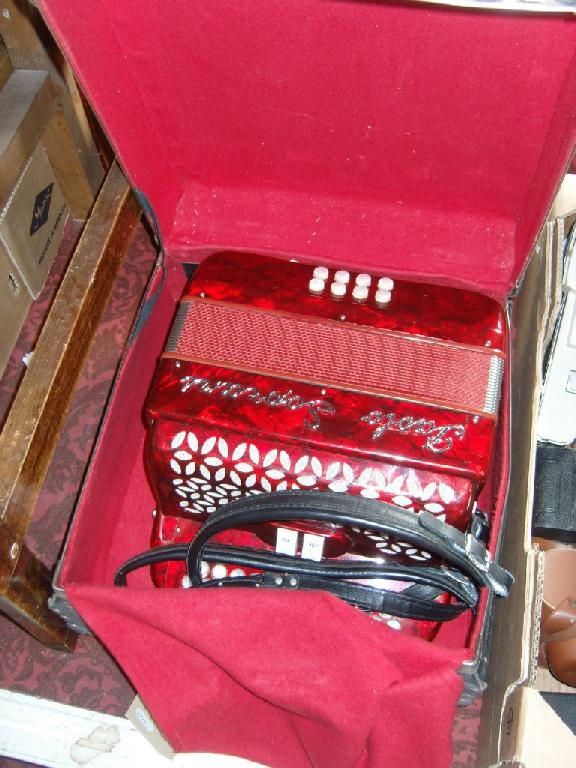 Appraisal: A cased Paolo Soprani piano accordion with decorative red finish