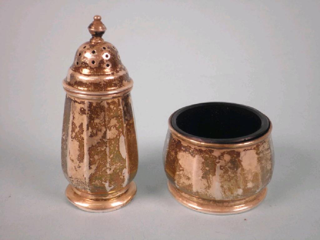 Appraisal: A facetted silver pepper pot with a turned knop and