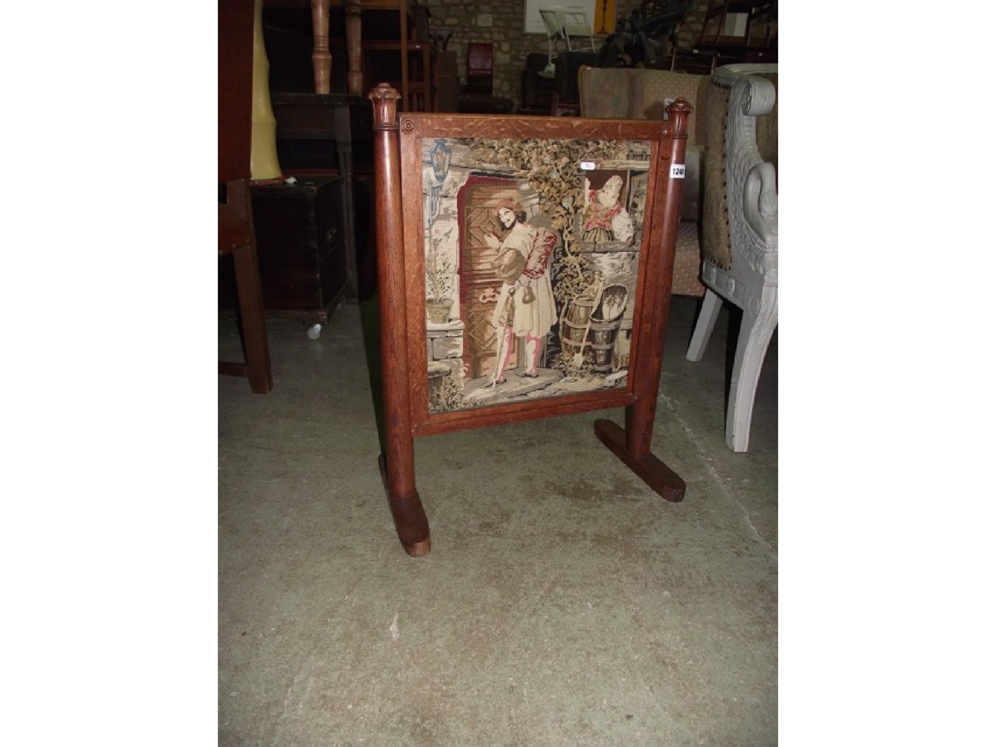 Appraisal: A th century oak framed fire screen the simple turned