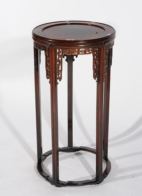 Appraisal: A CHINESE HARDWOOD CIRCULAR URN STAND with pierced carved brackets