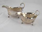 Appraisal: Two silver sauceboats with flying C scroll handles and hoof