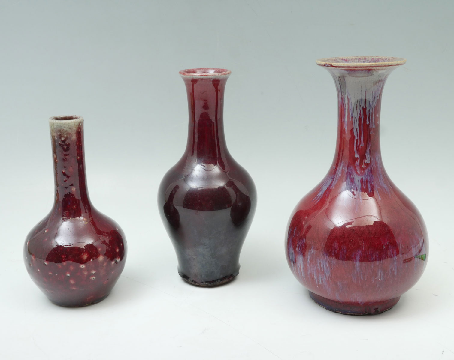 Appraisal: PC CHINESE FLAMBE BOTTLE VASES Chinese porcelain red glazed flambe