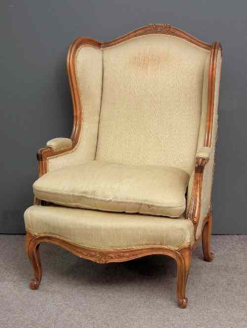 Appraisal: A French walnut framed wing back easy chair the back