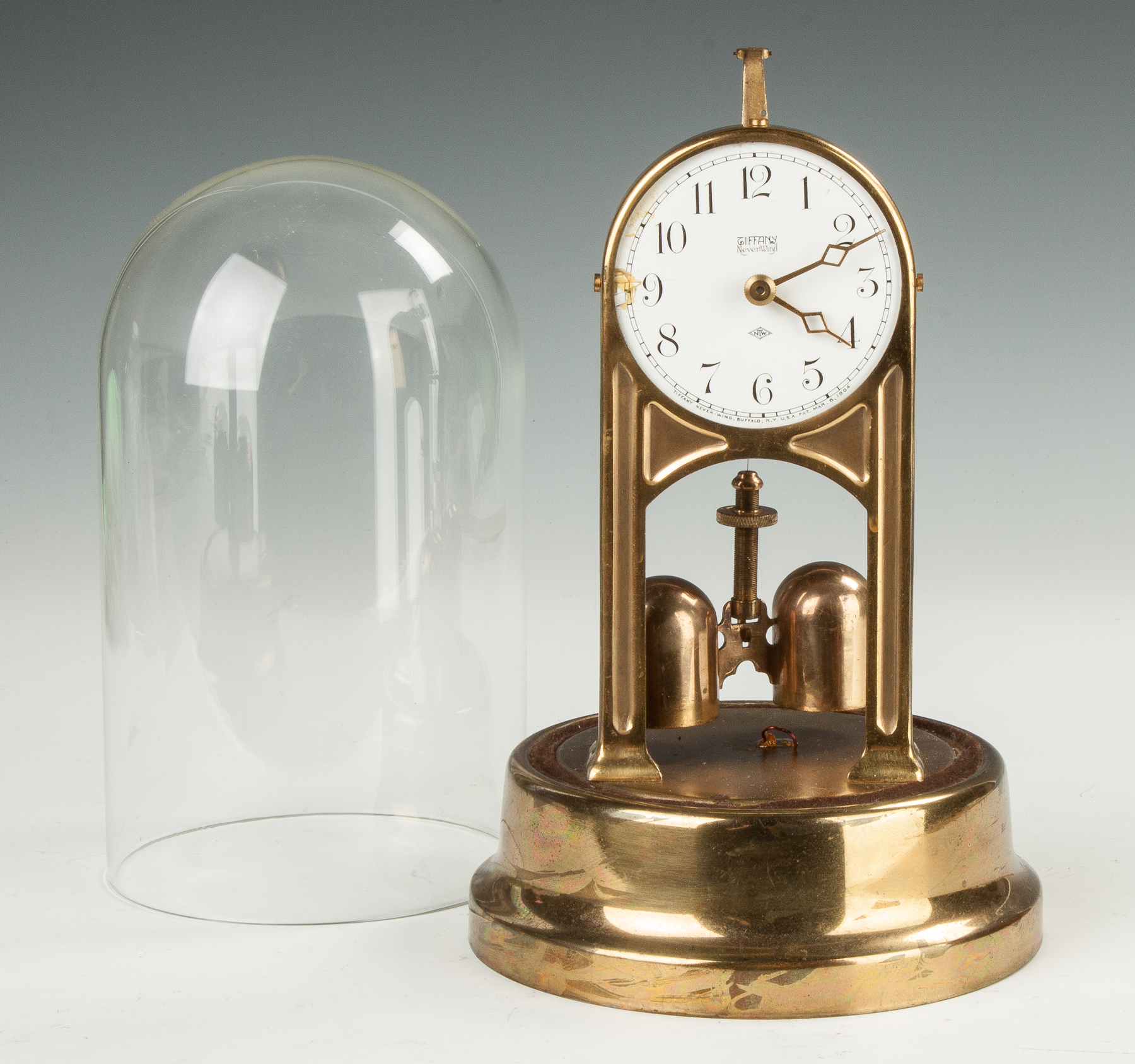 Appraisal: Tiffany and Co Never-Wind Brass case with electric movement Porcelain