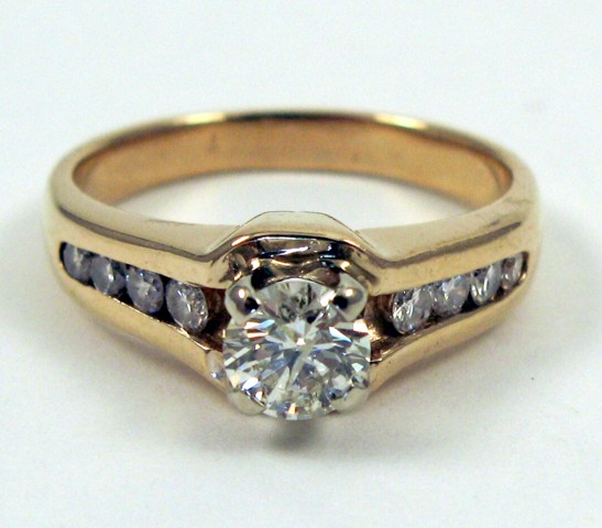 Appraisal: DIAMOND AND FOURTEEN KARAT GOLD RING centering a round brilliant-cut