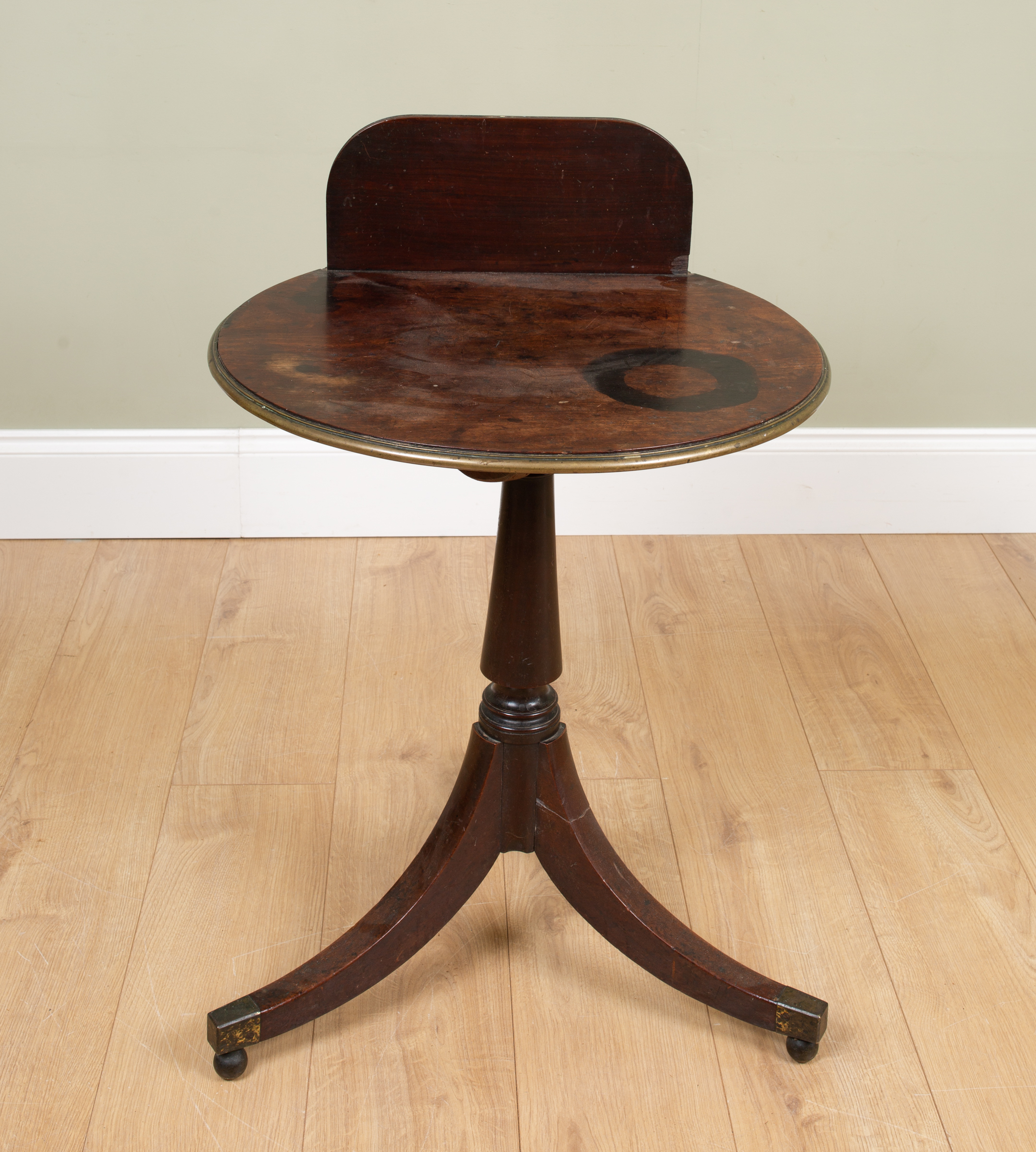 Appraisal: A th century mahogany tripod table with raised back moulded