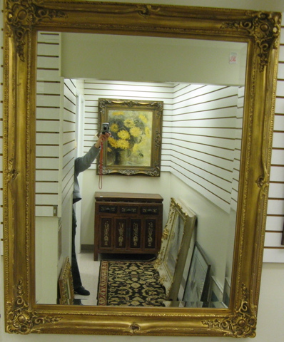 Appraisal: A RECTANGULAR GILT WOOD FRAMED WALL MIRROR with gesso corners