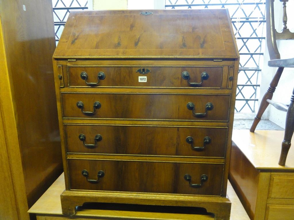 Appraisal: A reproduction yew wood veneered bureau in the Georgian style