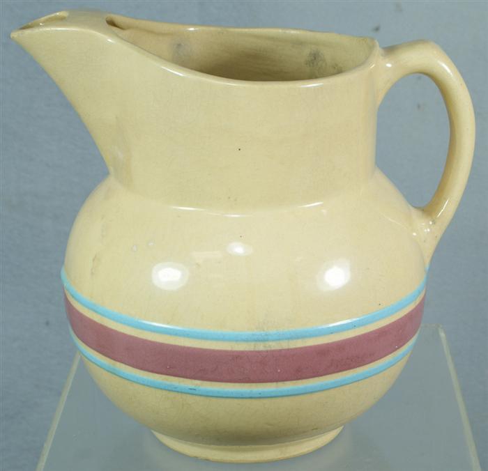 Appraisal: Yellowware pitcher with light violet and turquoise banded decoration signed