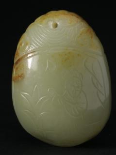 Appraisal: Chinese carved jade toggle Chinese white and russet jade toggle