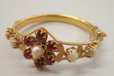 Appraisal: A cultured pearl and red gem set hinged bangle the