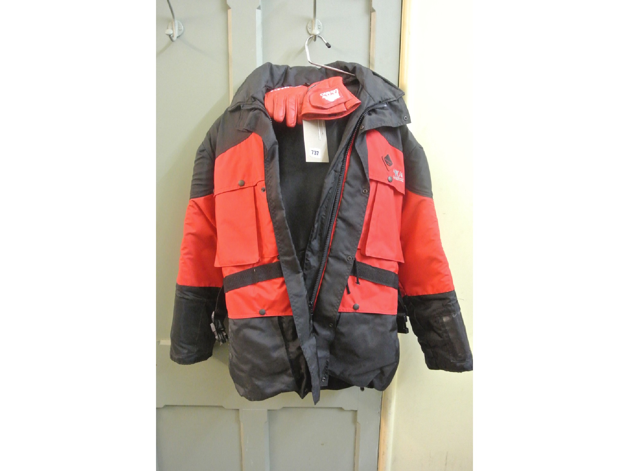 Appraisal: An Aqua black and red alternating coloured motorcycle jacket UK