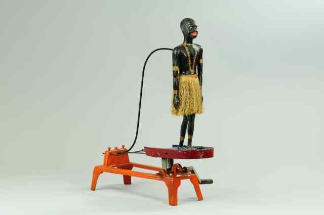 Appraisal: JIGGING FIGURE ON PLATFORM Hubley a scarce and early hand