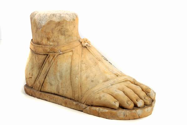 Appraisal: A Roman style carved marble sandaled foot height in