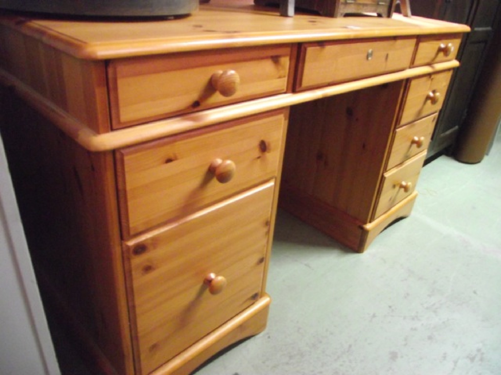 Appraisal: A contemporary stripped pine kneehole twin pedestal dressing table desk