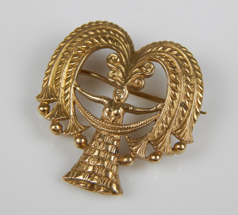 Appraisal: A brooch depicting a woman with headdress arms outstretched marked