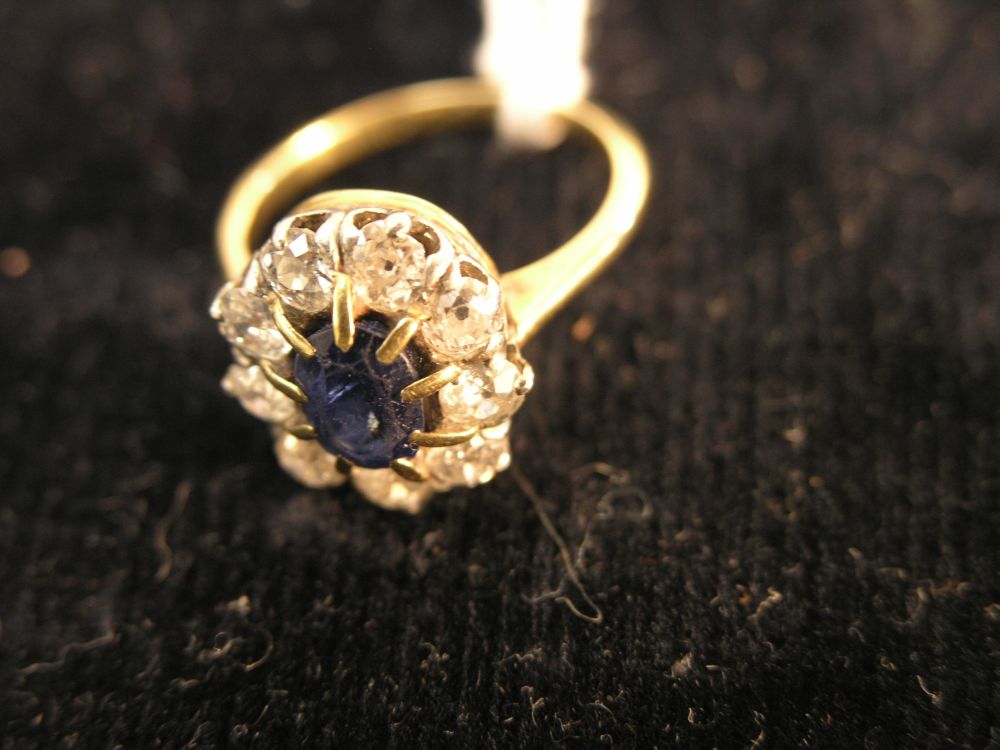 Appraisal: A gold and diamond cluster ring nine small diamonds around