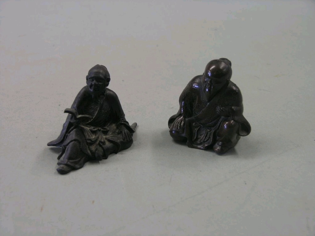 Appraisal: Two small bronze figures bearded elder seated reading book in