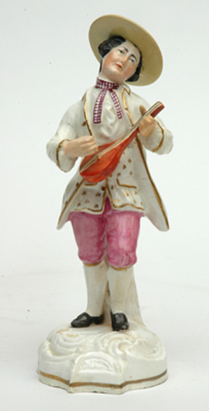 Appraisal: AN EARLY TH CENTURY STAFFORDSHIRE FIGURE OF A MUSICIAN The