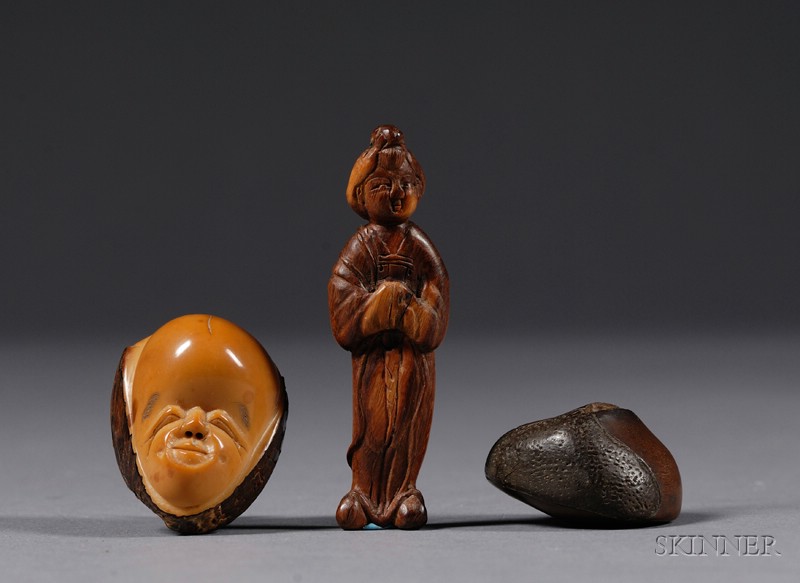 Appraisal: Three Netsuke a chestnut a carved palm nut and a