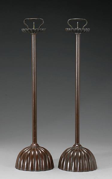 Appraisal: A pair of brown lacquered copper-alloy candle stands Taisho Showa