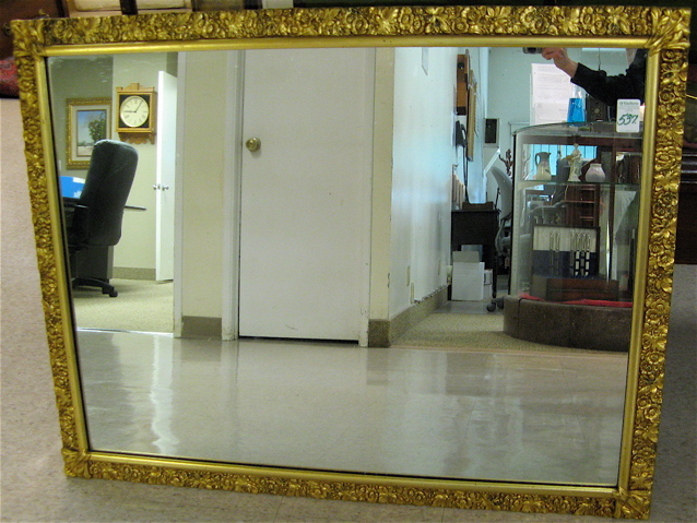 Appraisal: AN AMERICAN RECTANGULAR WALL MIRROR having gilt wood frame covered