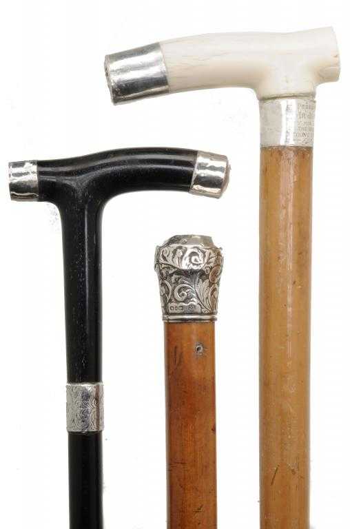 Appraisal: THREE SILVER-MOUNTED WALKING CANES one of ebony the others malacca