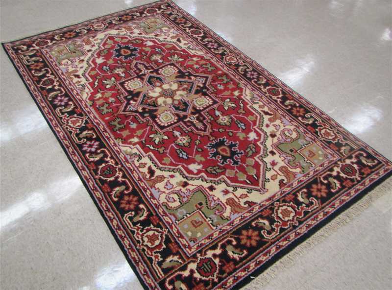 Appraisal: HAND KNOTTED ORIENTAL CARPET Indo-Serapi central geometric medallion and stylized