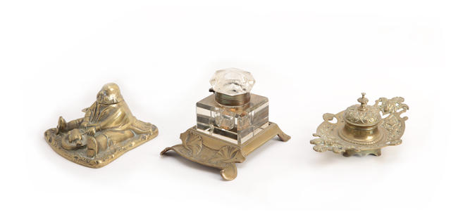 Appraisal: A brass inkwell modelled as a seated man eating a