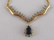 Appraisal: A yellow metal test carat gold sapphire and diamond pendant