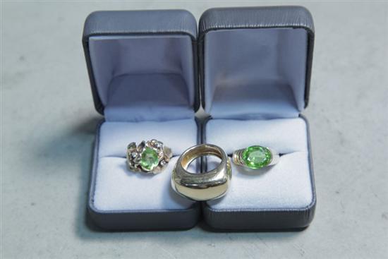 Appraisal: THREE GOLD RINGS One with green center stone and marked