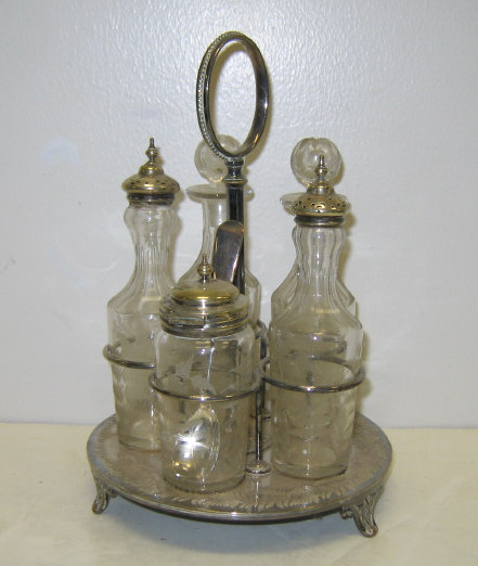 Appraisal: SILVER ON COPPER FIVE-BOTTLE CRUET STAND The circular footed base