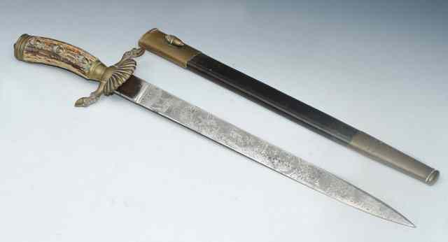 Appraisal: A GERMAN HUNTING SWORD with bone handle and stylised brass