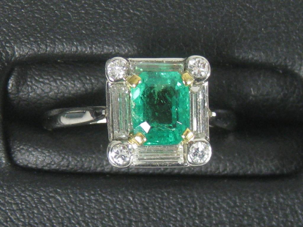 Appraisal: An Emerald and Diamond Ring the step-cut emerald claw-set within