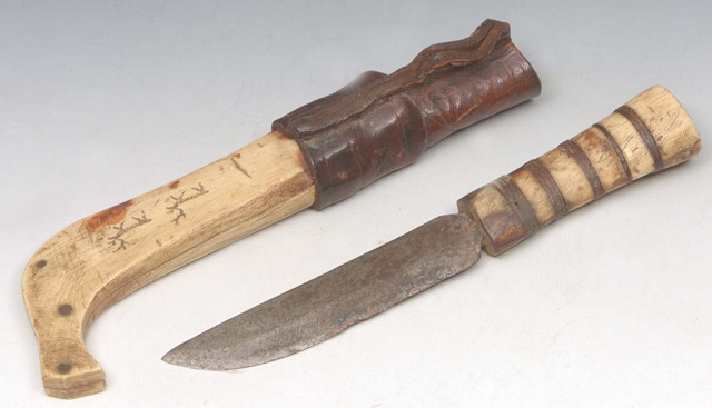 Appraisal: AN INUIT CARVED BONE DAGGER with leather handle with naive