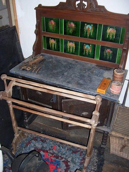 Appraisal: An Edwardian tile back washstand the polished stone surface over