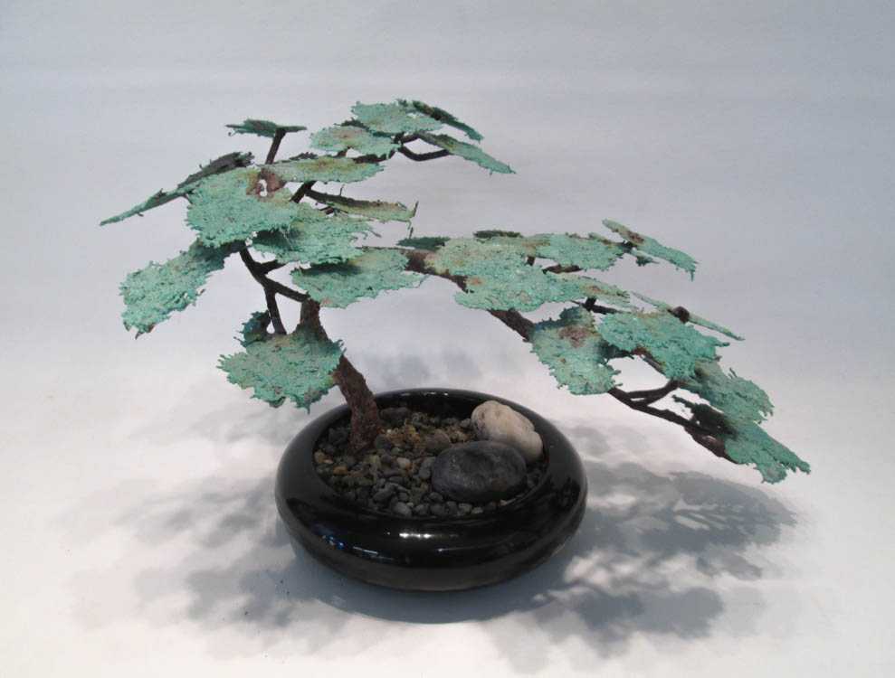 Appraisal: BRONZE BONSAI TREE SCULPTURE with green painted leaves and set