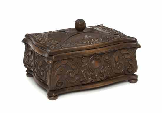 Appraisal: A Carved Walnut Box of shaped rectangular form with a