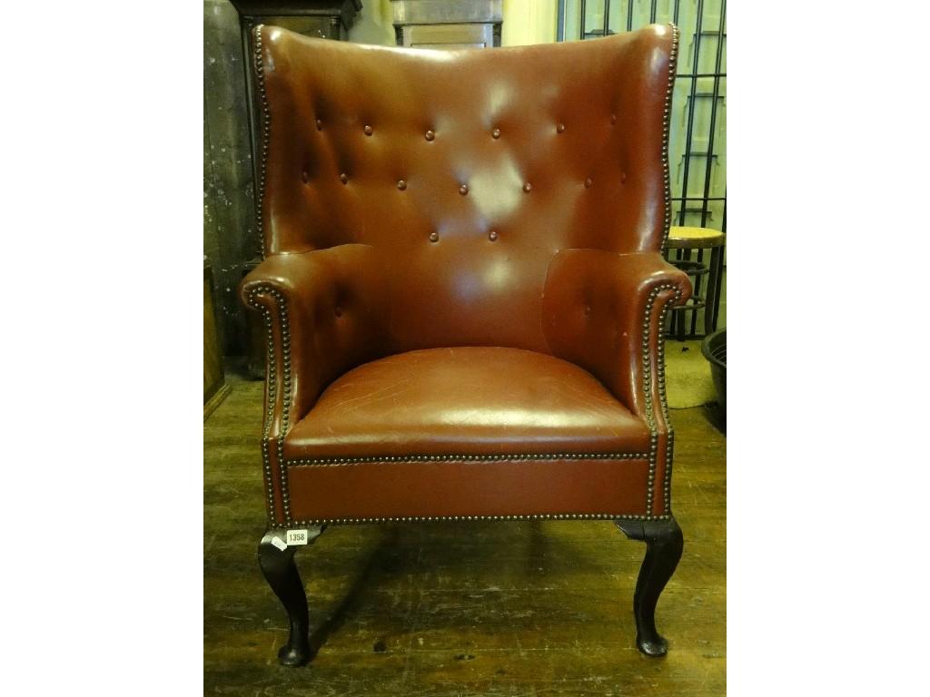 Appraisal: A Georgian style armchair the winged barrel shaped back with