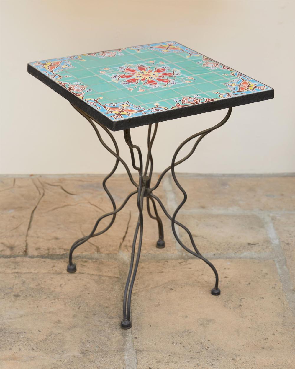 Appraisal: A tile-top wrought iron garden table th Century The small