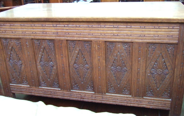 Appraisal: An th century style carved oak coffer the plank top