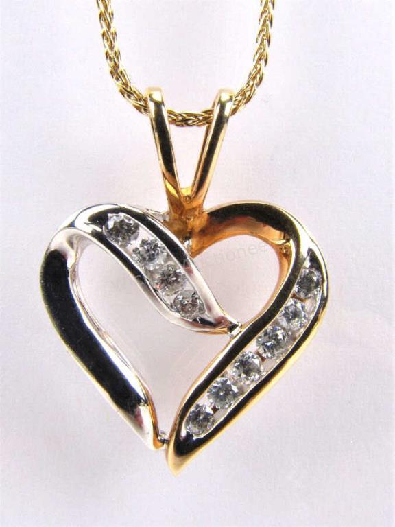 Appraisal: A K white and yellow gold crossover design heart pendant