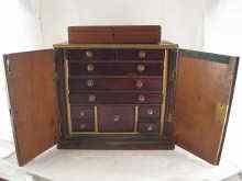 Appraisal: A heavy Indian hardwood brassbound cabinet the interior fitted with