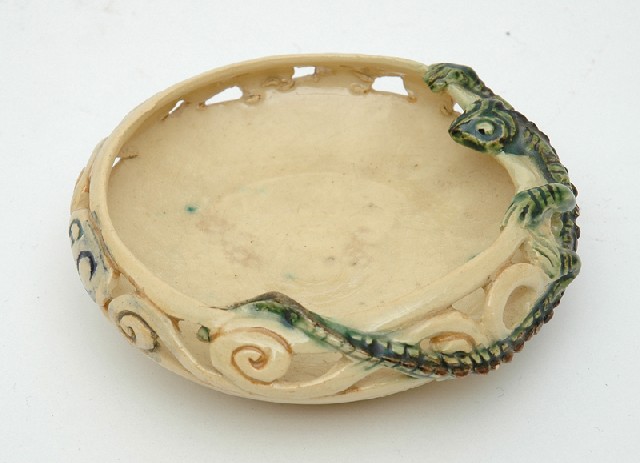 Appraisal: MARGUERITE MAHOOD - Victoria circa A pierced earthenware dish modelled