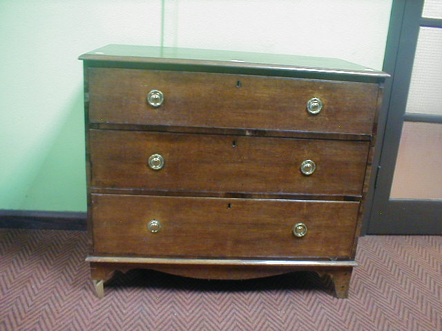 Appraisal: A Georgian oak three drawer chest with brass ring handles