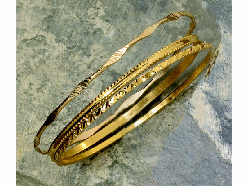 Appraisal: BANGLE BRACELETS Three designed bangle bracelets One k Two high