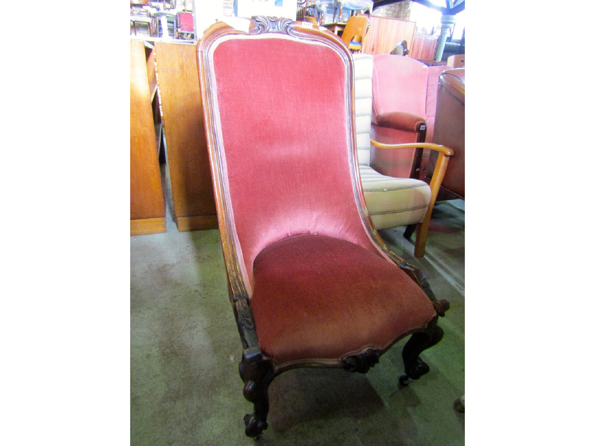 Appraisal: A Victorian nursing chair with serpentine upholstered seat and back