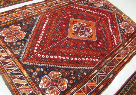 Appraisal: TWO PERSIAN SHIRAZ AREA RUGS ' X ' five geometric