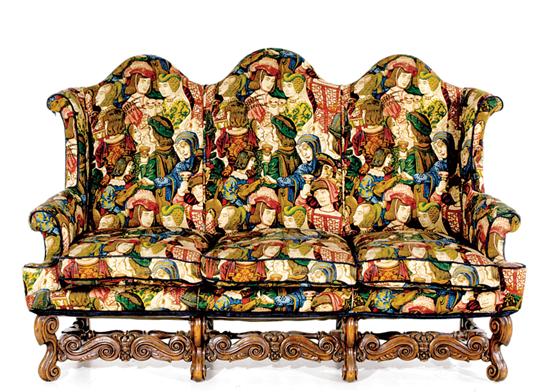 Appraisal: English carved and upholstered tripleback settee circa domed high backs