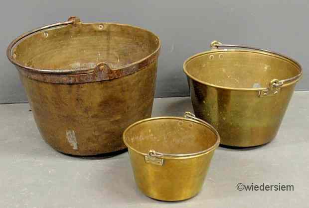 Appraisal: Three th c brass pails each with an iron swing